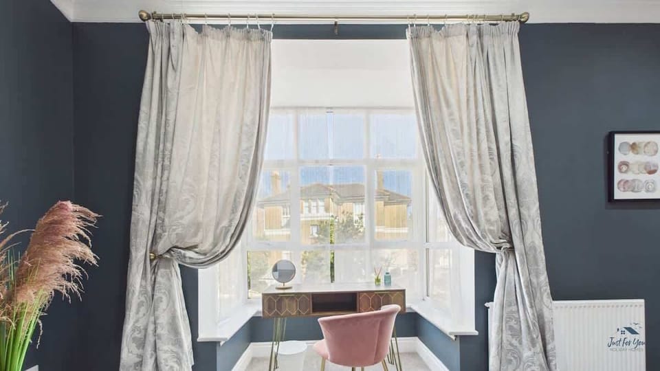 A dedicated dressing area in the master bedroom with a mirror and ample light for getting ready.