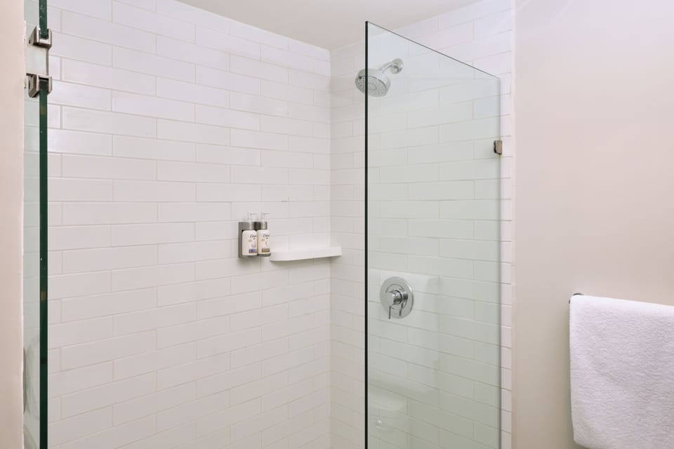 Shower, rainfall showerhead, hair dryer, towels