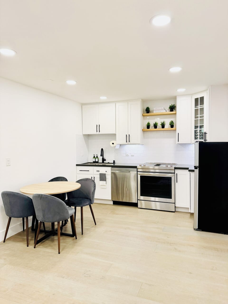 Open kitchen layout with a dishwasher, electric range, refrigerator.