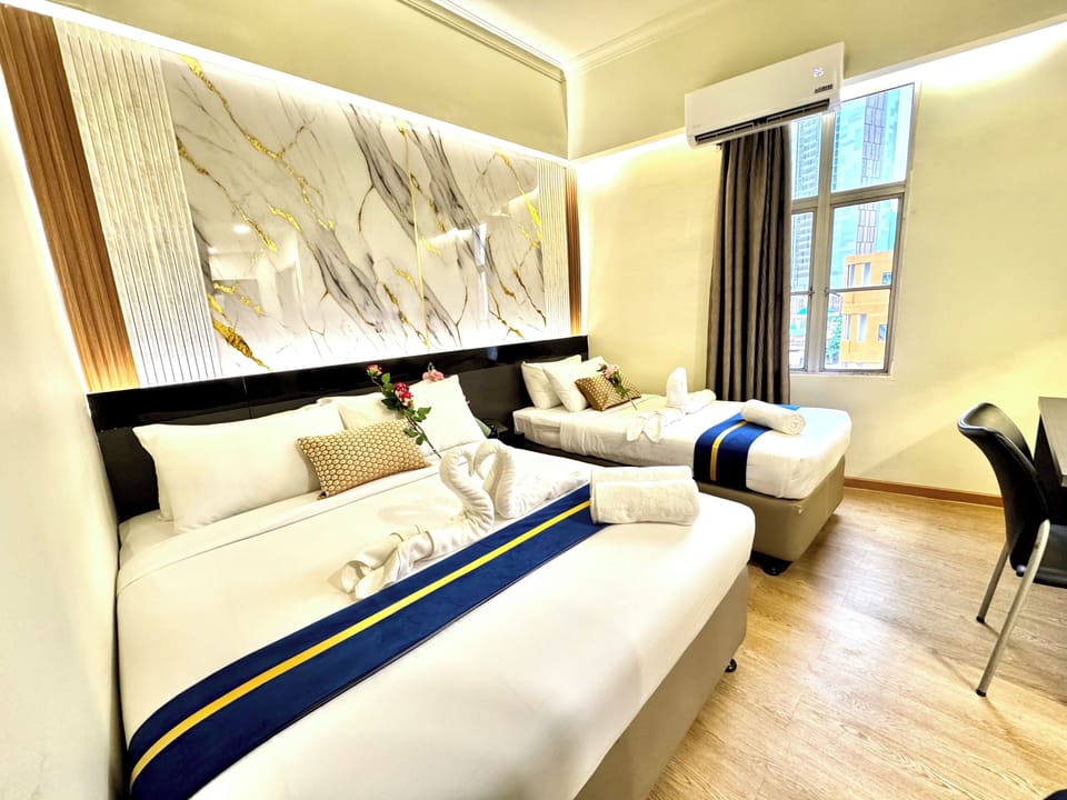 Deluxe Triple Room with Window | In-room safe, desk, laptop workspace, soundproofing