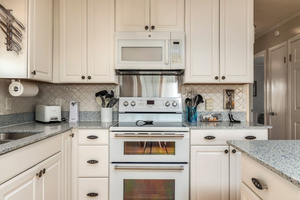 Prepare your favorite meals in this beautifully appointed kitchen with granite counters, premium appliances, and thoughtful touches.