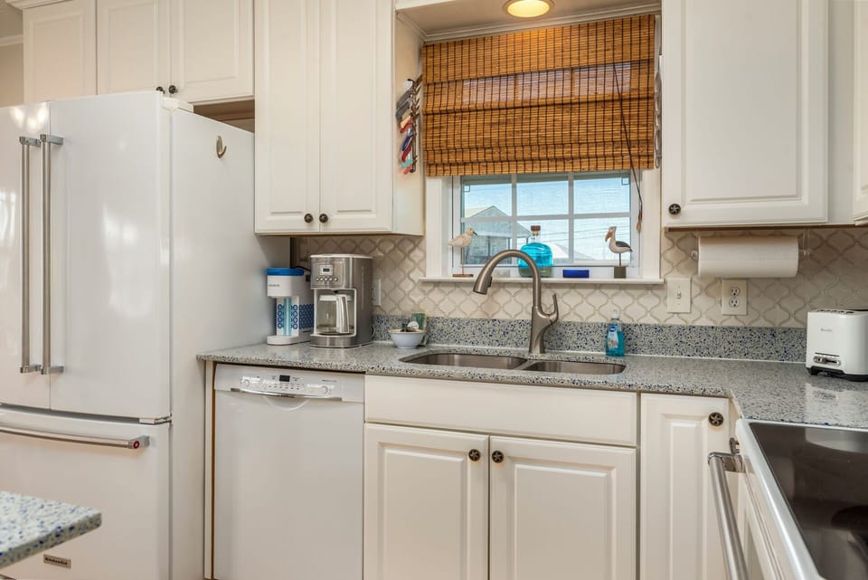 Your fully equipped kitchen features granite counters, stainless appliances, and everything needed for cooking meals during your stay.