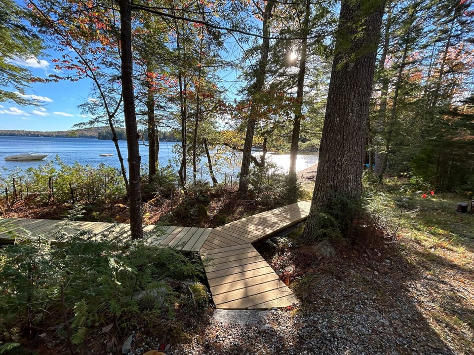Boardwalk leading from deck to beach to the right and dock to the left.