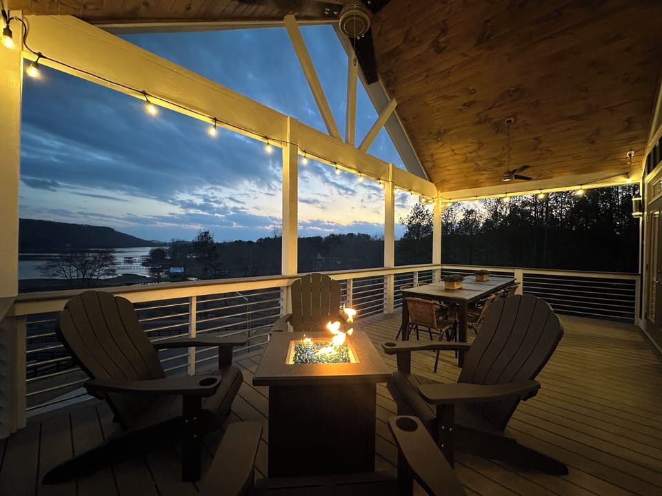 Main level balcony accompanied by a firepit & large outdoor dining table!