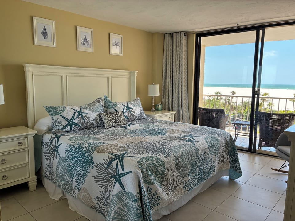 Master bedroom with a king size bed and balcony with a Gulf/beach view.