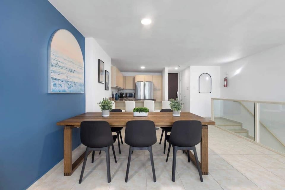 Gather and create memories in this inviting open-concept space. Perfect for shared meals and lively conversations, featuring a stylish dining area and a well-equipped kitchen.