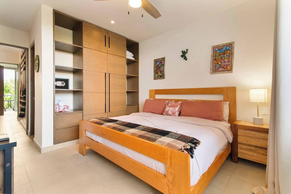 Master bedroom with safe, wardrobe, private bath, and beach towels.