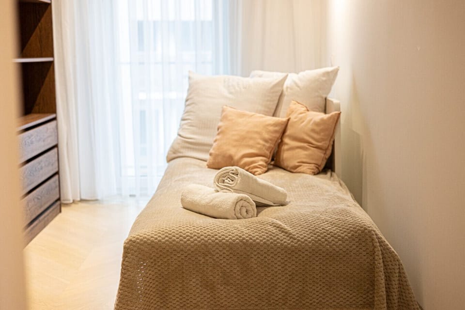 The second bedroom, modest yet cozy, offers comfort and tranquility. A spacious wardrobe provides convenient storage, creating a perfect space for relaxation and rest.