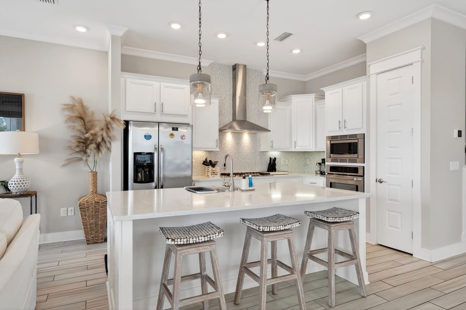 A bright, designer kitchen with a spacious island—perfect for coffee mornings, quick bites, and family-style dinners.