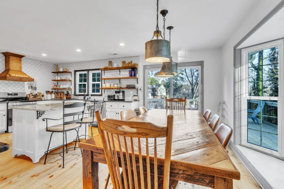 Gather around the rustic 8-seater wood dining table, perfect for meals or game nights. The granite bar top adds extra seating and style, ideal for casual dining or coffee. South-facing windows offer stunning forest views, bringing natural light indoors.
