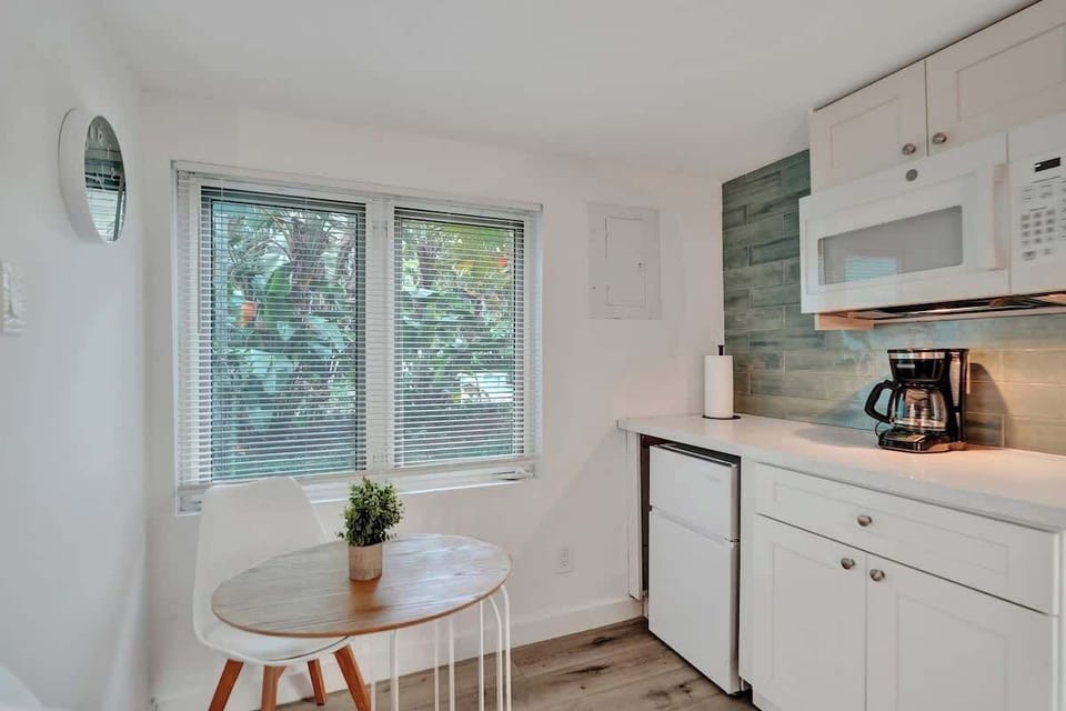 Compact kitchen with dining nook and garden view