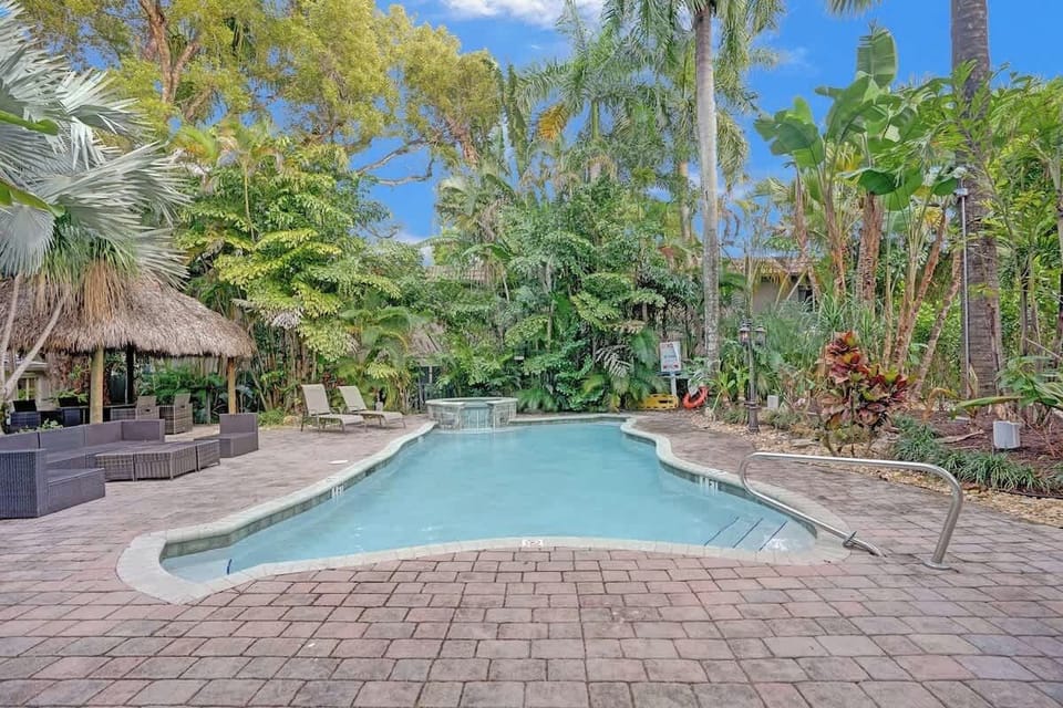 Sparkling tropical pool surrounded by lush palms