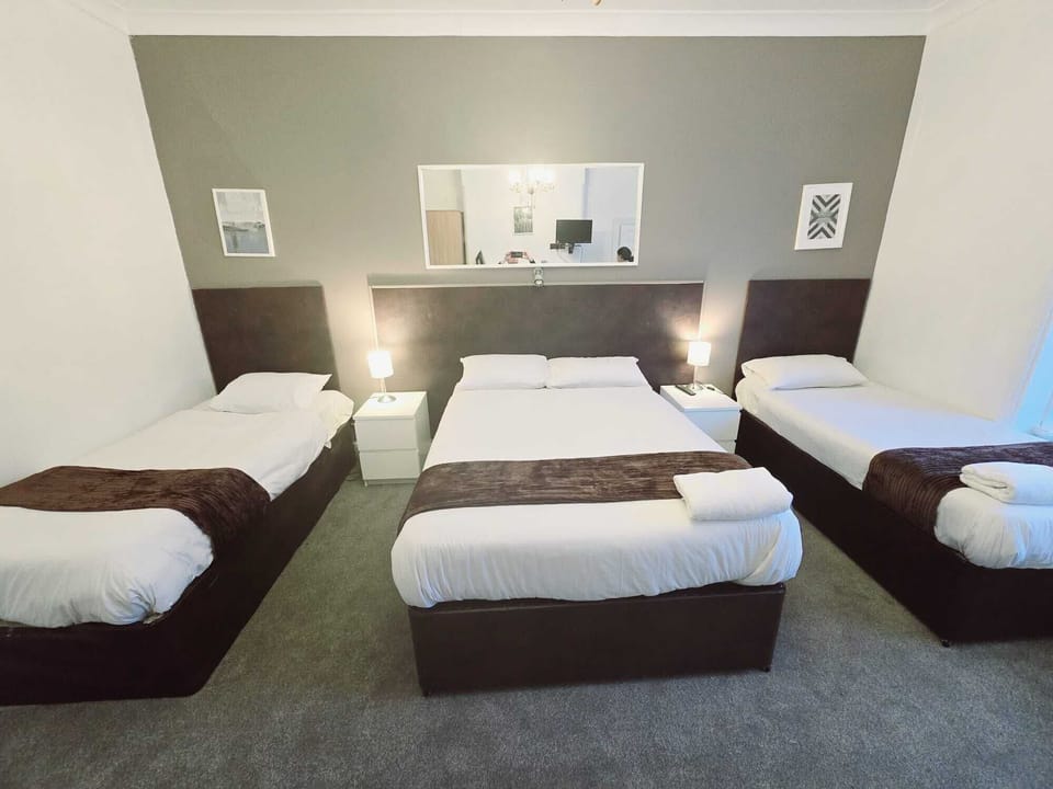 Family Room, Multiple Beds | Desk, laptop workspace, free WiFi, bed sheets
