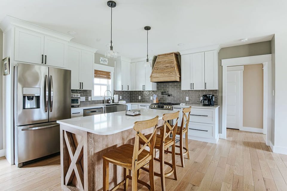 Fully equipped kitchen with modern appliances, ample counter space, coffee maker, toaster, and cookware.