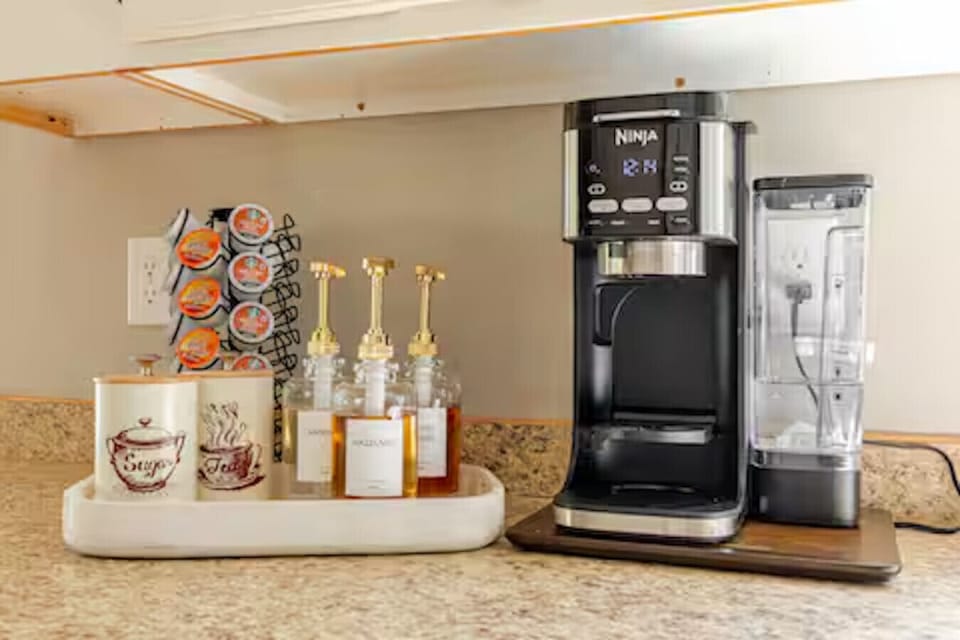 coffee bar with pods, tea, sugar, and syrups