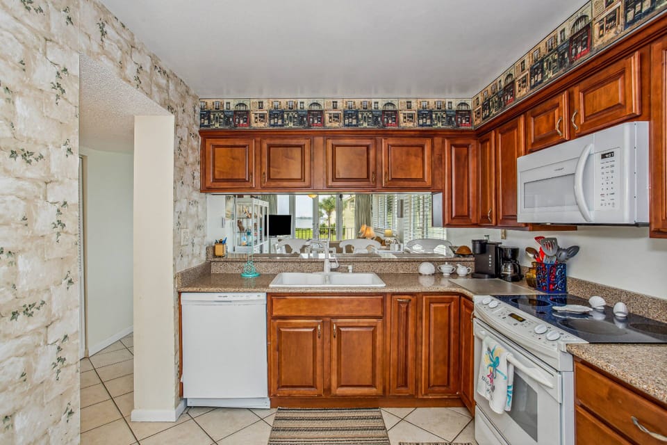 Fully equipped kitchen with white appliances and granite counters