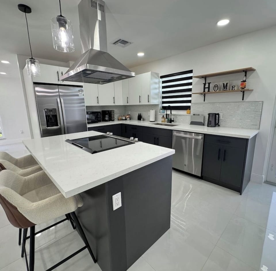 The kitchen is modern and well equipped with appliances, a large island and plenty of counter space. It is perfect for preparing homemade meals.