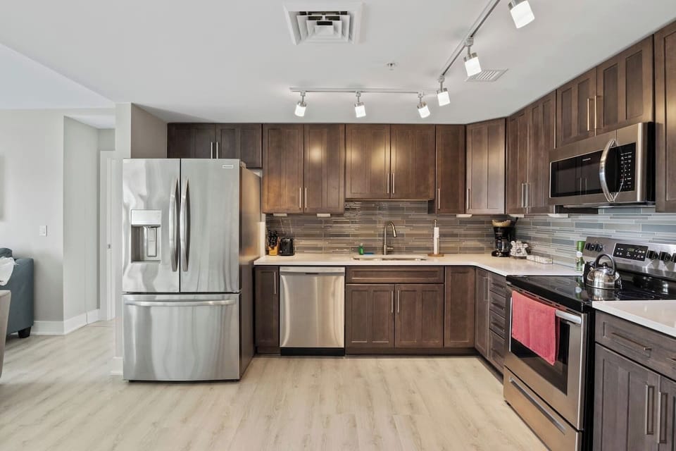 Fully equipped kitchen with fridge, stove, oven, microwave, sink, and all cooking supplies provided for your convenience.