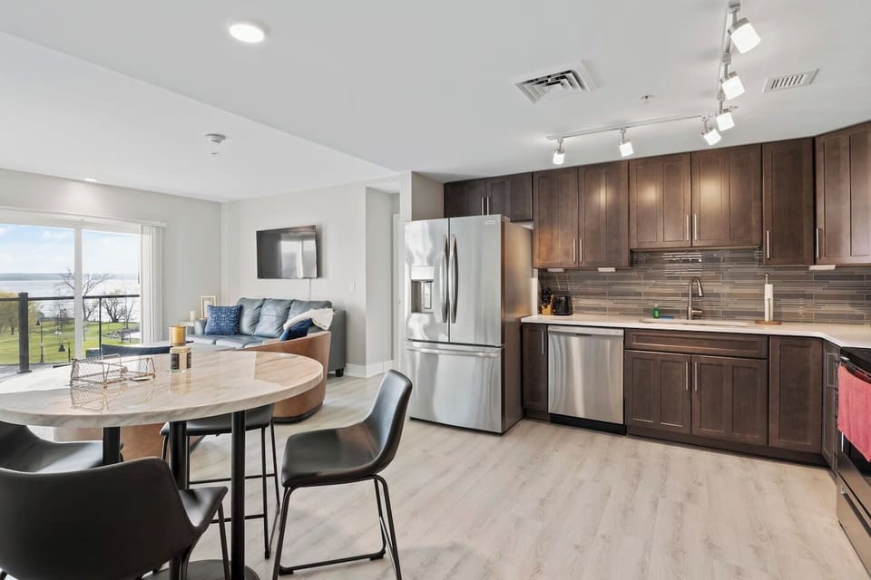 Compact yet cleverly designed, this kitchen boasts ample storage and workspace, making meal preparation a breeze. The dining area comfortably accommodates four, inviting cozy gatherings over delicious meals. 