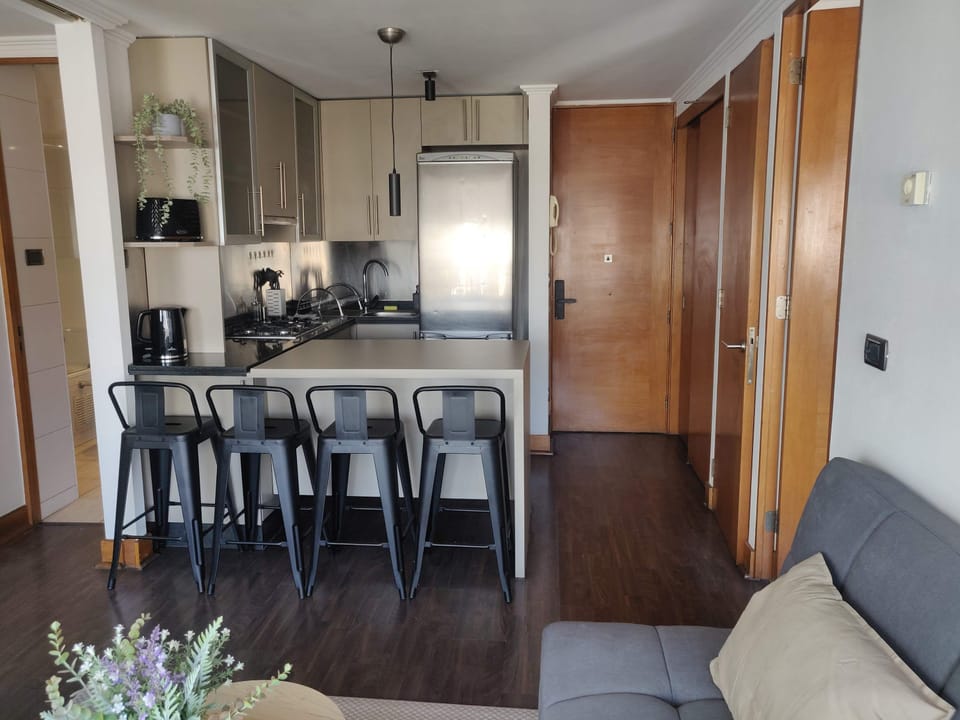 Modern kitchen with sleek appliances and a cozy seating area, perfect for enjoying meals and gatherings.