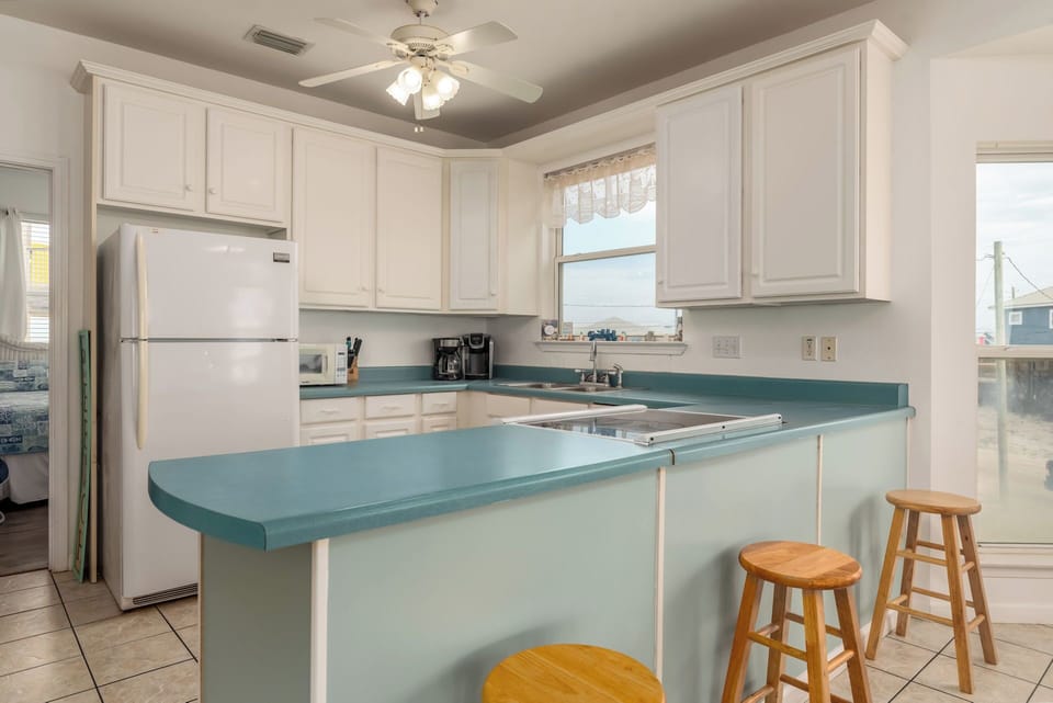 Cook your favorite meals in this bright, fully-equipped kitchen with modern appliances and charming breakfast bar seating.