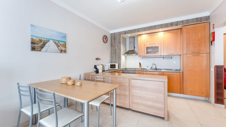 Fully equipped kitchenette with modern appliances and a dining area for home-cooked meals or cozy breakfasts. #HomeAwayFromHome #ModernKitchenette
