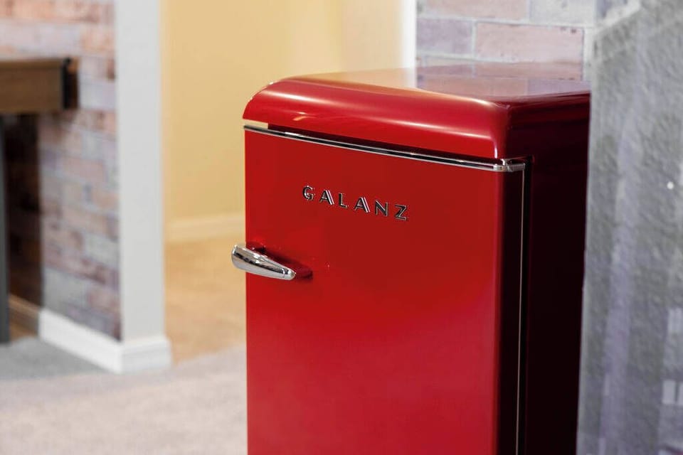 Enhance your stay with a striking red retro refrigerator that adds charm against the warm exposed brick. The inviting walls create a cozy atmosphere, perfect for meal prep or late-night snacks. Enjoy the experience!