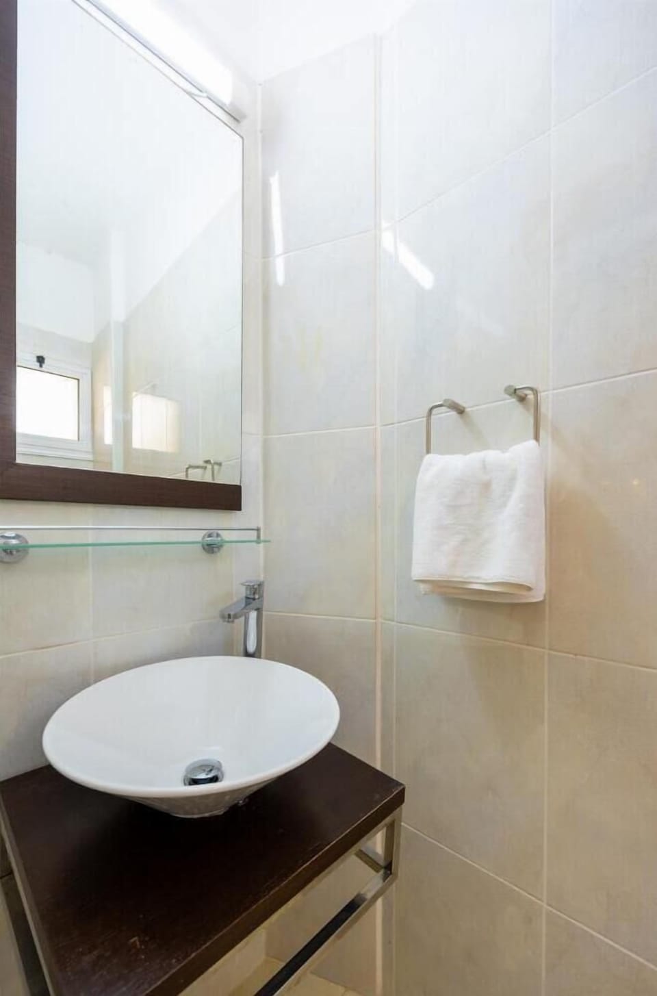 An interior view of the vanity station within the compact guest restroom, highlighting its modern fixtures and space-saving design.