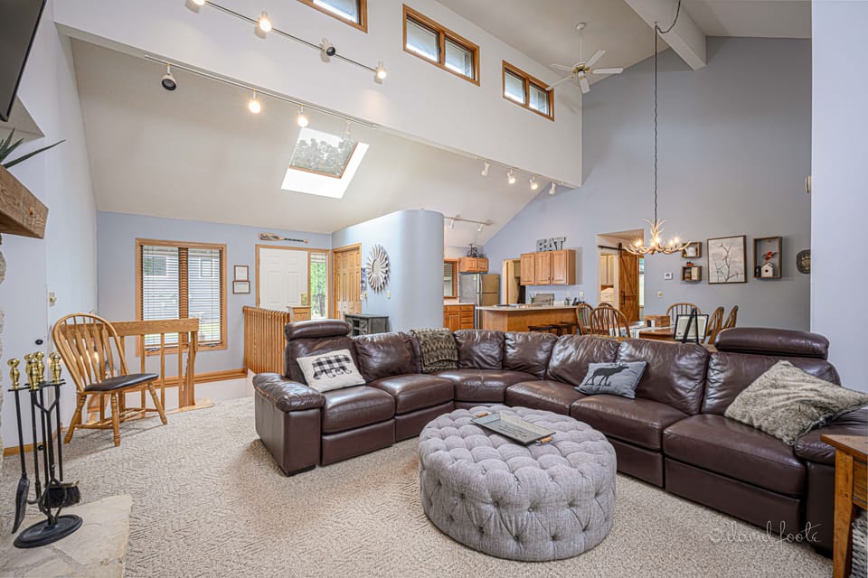 The great room features a beautiful open floor plan with vaulted ceilings. 