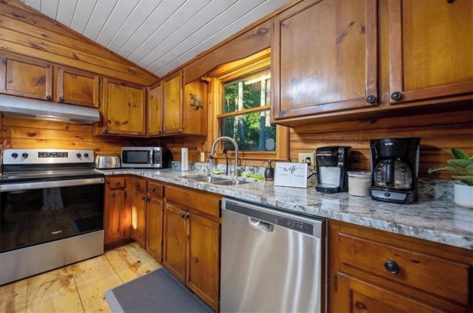 Renovated kitchen featuring granite countertops and stainless steel appliances.