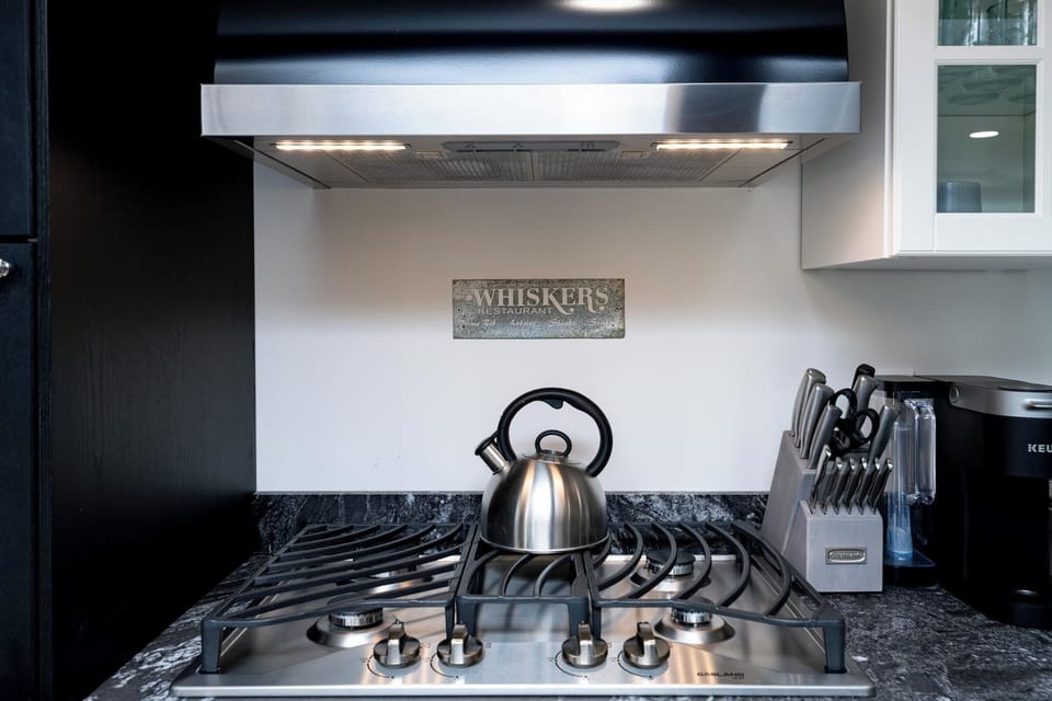 Fully stocked kitchen with a stainless steel gas stove, perfect for meals.