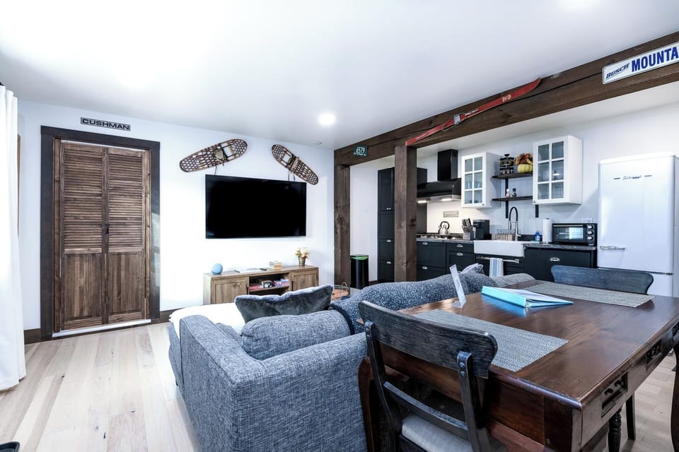 Bright living space with comfy seating, 4K TV, and cozy board games to enjoy.