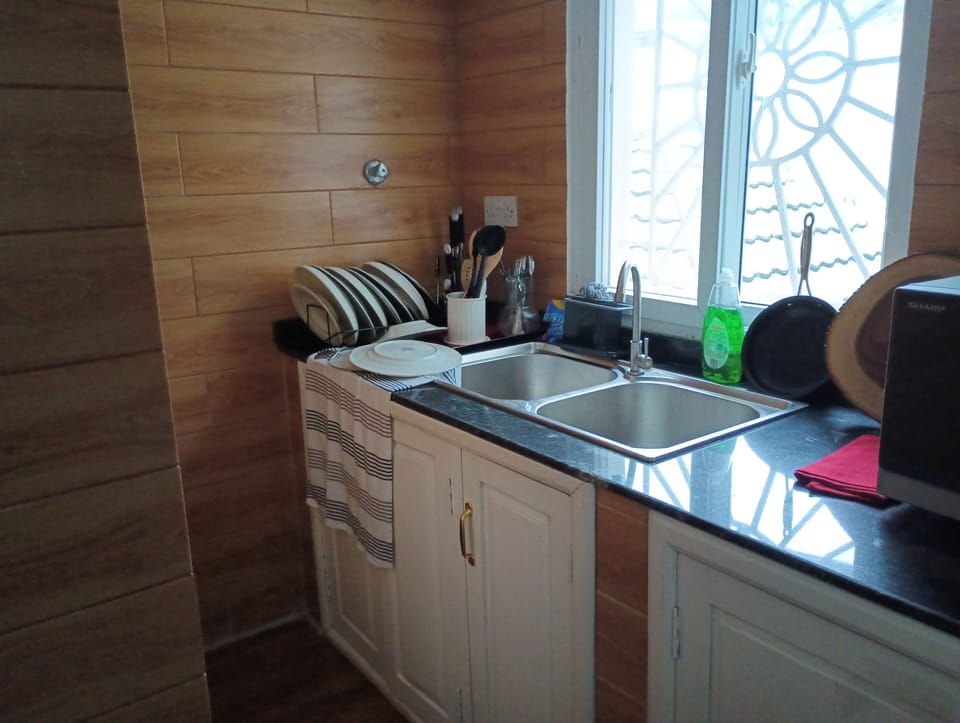 Kitchen equipped with utensils and plates, cups and cutlery