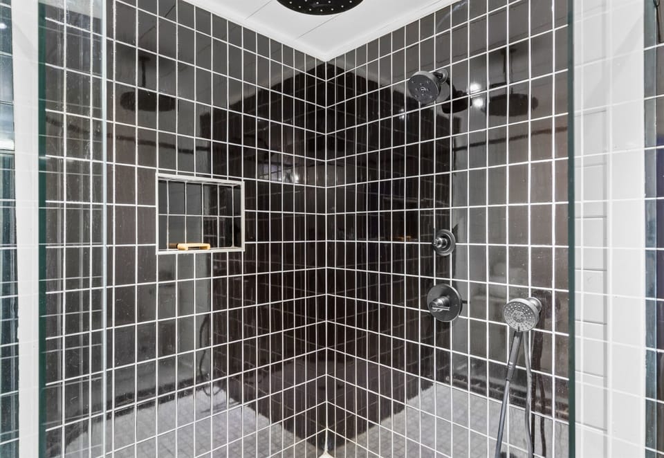 Enjoy the spa-like feel of this oversized shower, complete with stunning tile accents.