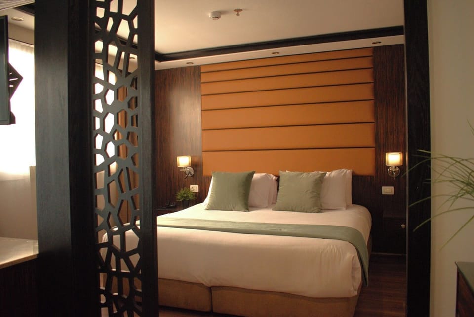 Junior Suite, River View | Minibar, in-room safe, desk, laptop workspace