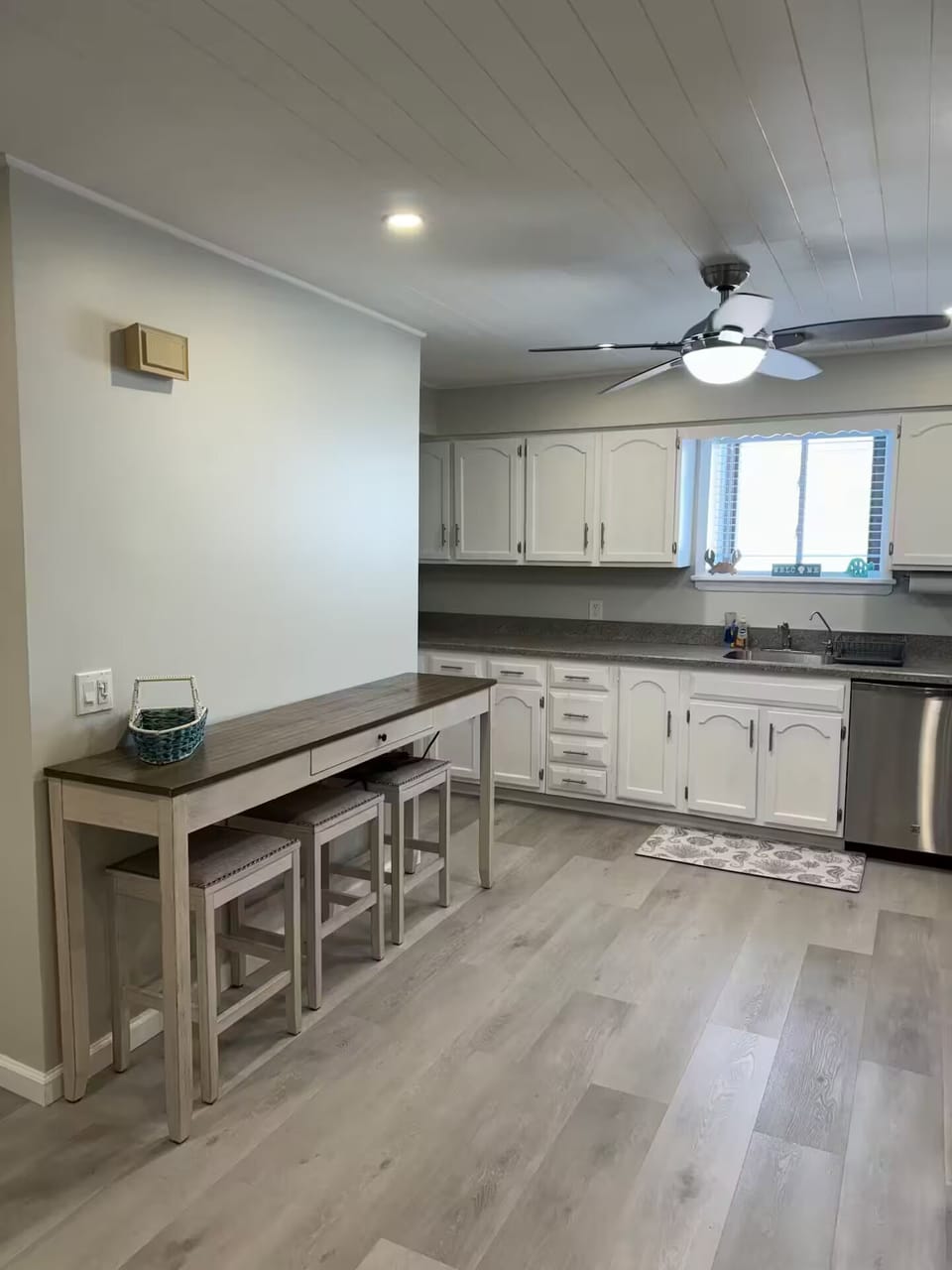 Breakfast bar with three barstools for additional seating.