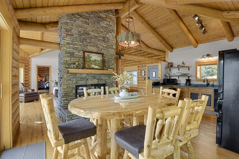 Dining room table for 6 sits next to sliding glass doors that have direct view of Pike`s Peak