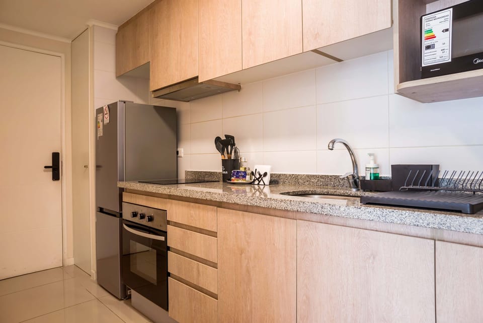 Modern kitchen with sleek appliances and ample counter space, perfect for cooking during your stay.