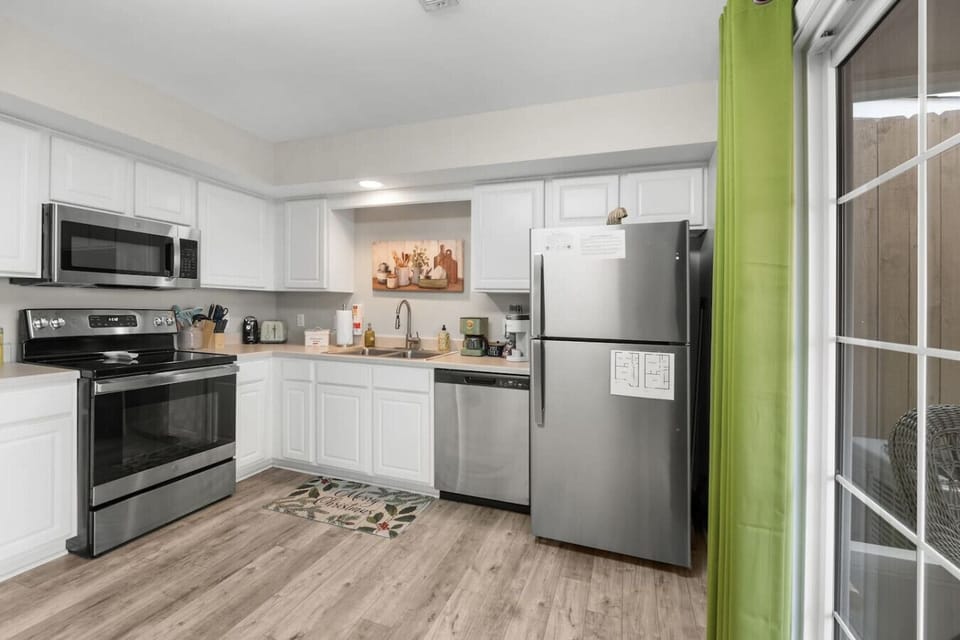The kitchen includes stainless steel appliances, silverware, cookware, dishware and more.