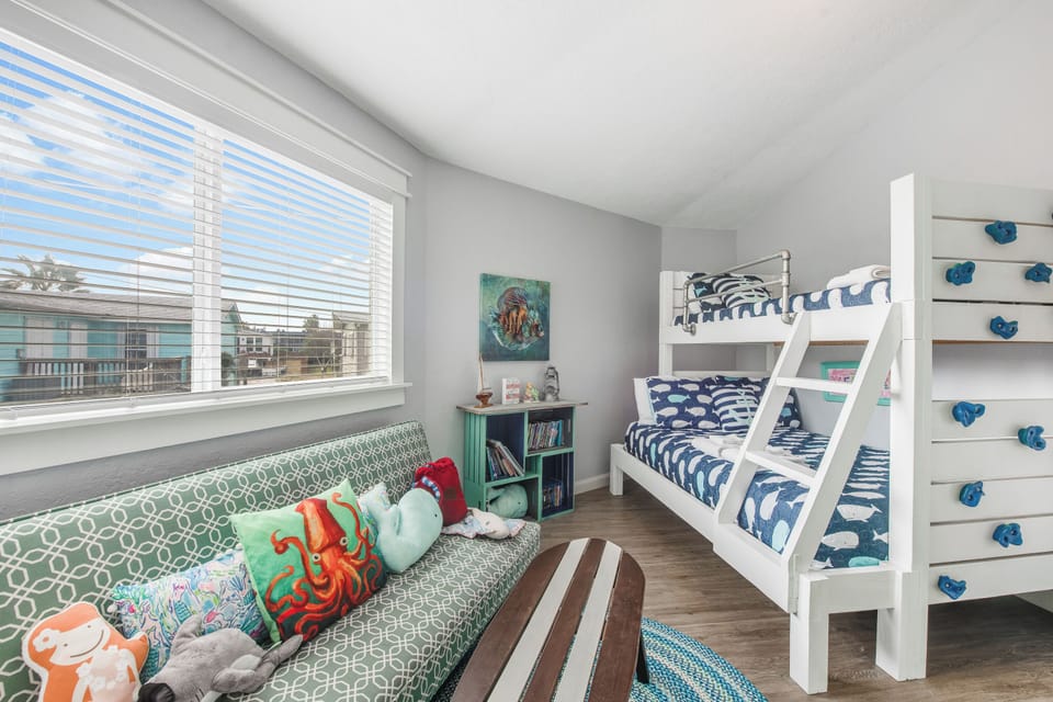 Your kids will love this bright, ocean-themed bedroom with comfy bunk beds and a cozy reading corner by the window.