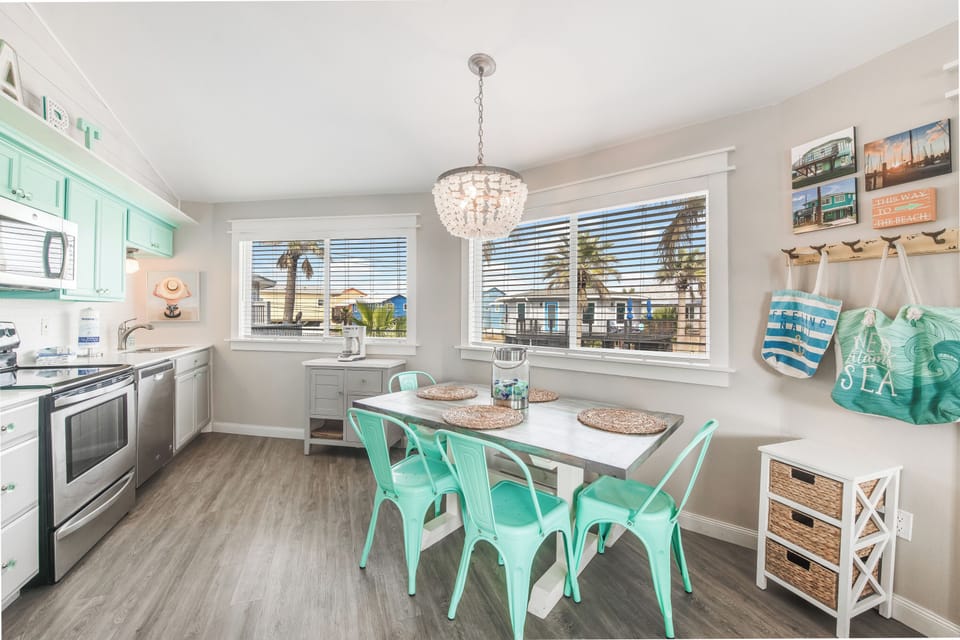 Gather around your spacious dining table in this bright, beachy kitchen where coastal charm meets modern comfort for memorable meals together.