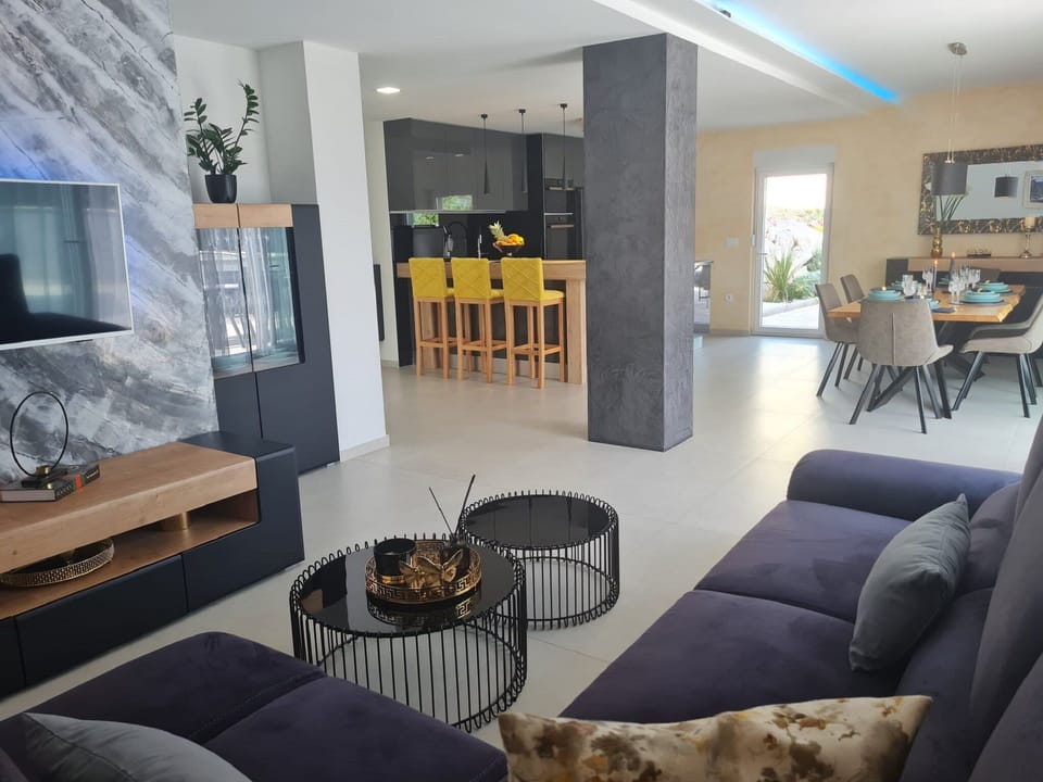 Villa (Four - Bedroom Villa) | Living room | 32-inch flat-screen TV with satellite channels