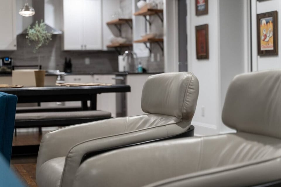 Relax in the living room on a cozy leather couch, perfect for reading or watching TV.