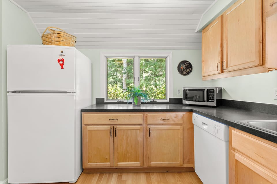 Cabinets contain full set of dishware, cutlery, pots, and pans