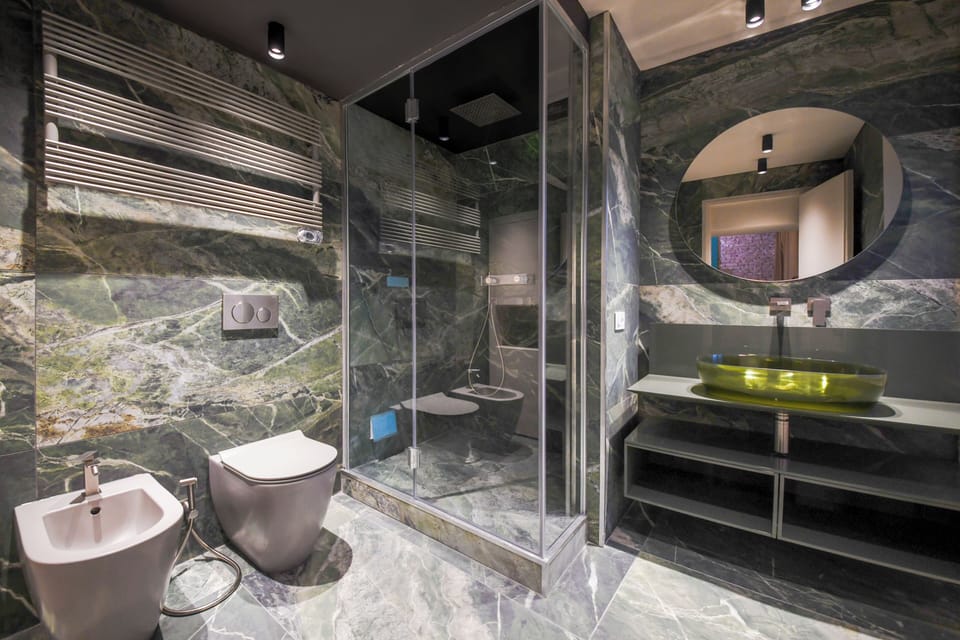 Executive Suite, City View | Bathroom | Designer toiletries, hair dryer, bathrobes, slippers