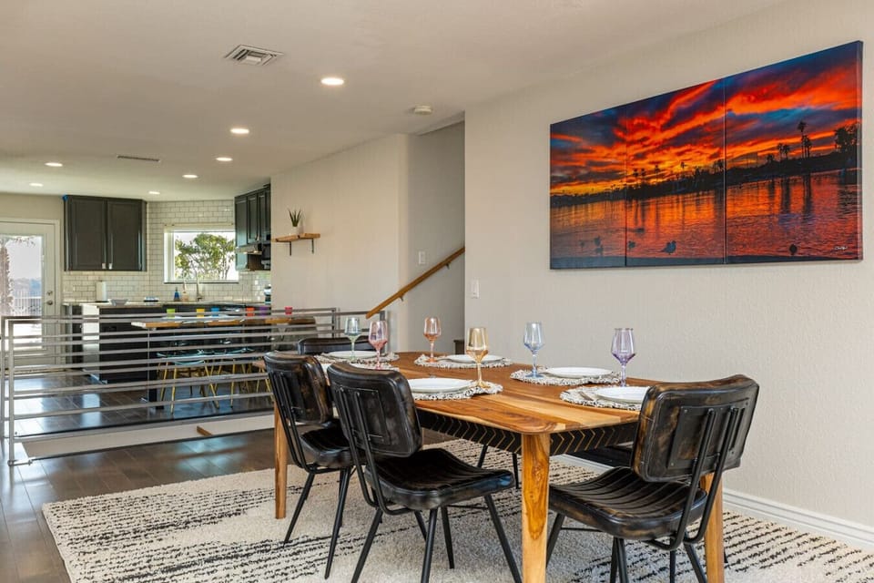 Dining table next to living room space that can seat up to 6 people