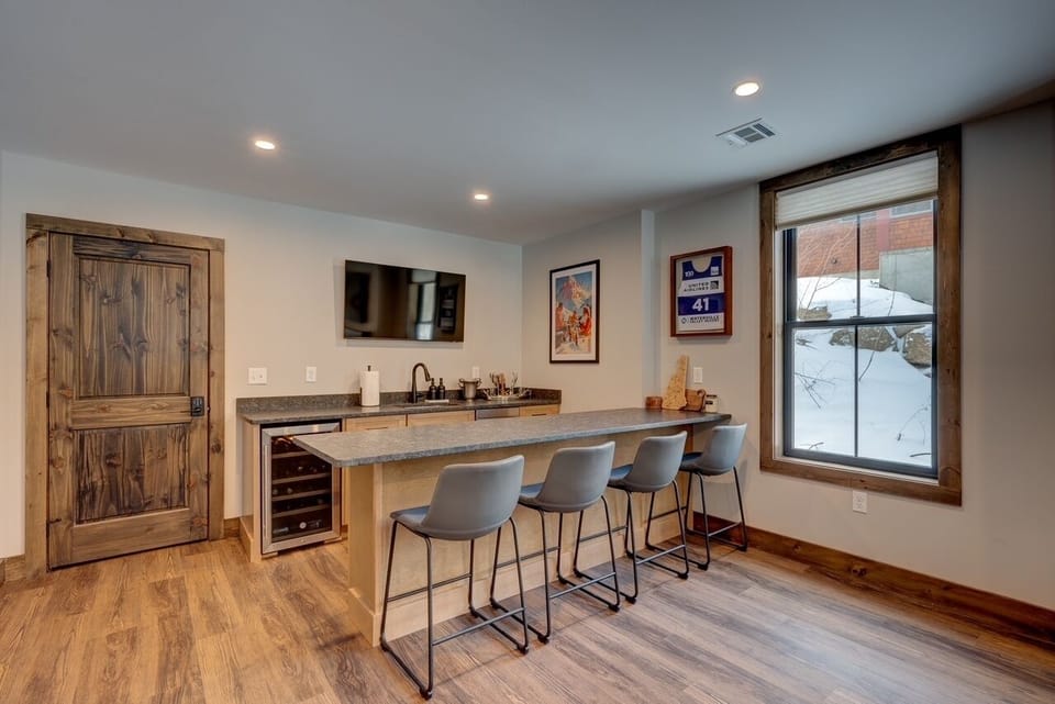 Wet bar with a 55' TV, dishwasher, wine cooler