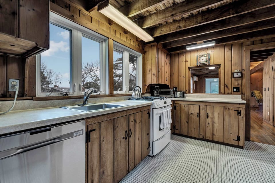 Whip up your favorite meals in this cozy, wood-paneled kitchen, designed to feel like a natural extension of the great outdoors.