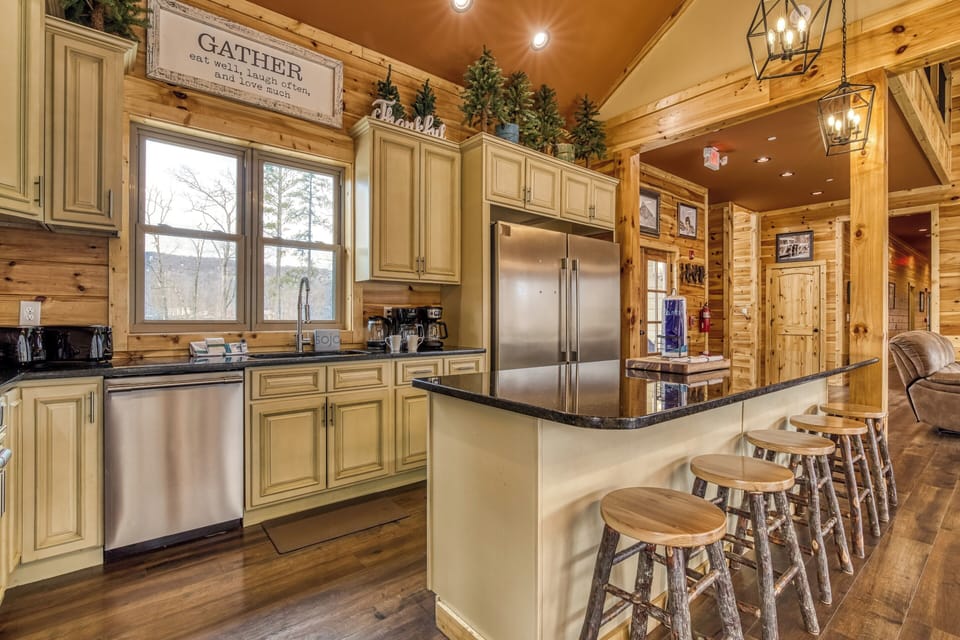 Vacation Rental with a Pool in Gatlinburg "Smoky Mountain Gold" - Fully furnished kitchen with kitchen island with additional seating