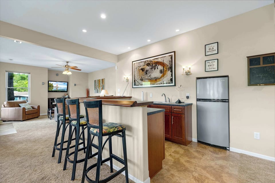 Basement game room with wet bar, pool table, and shuffleboard
